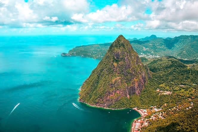 The Pitons of St. Lucia rising from the Caribbean Sea with yacht in foreground